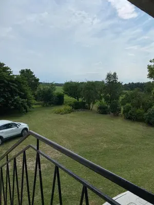a car parked on a balcony with a field at Maison T4 dans ancien corps de ferme avec lac in Gaudiès