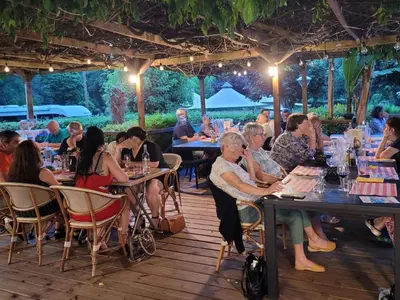 a group of people sitting at tables in a restaurant at Mobil-home à Pamiers, 4 Pers, 2 Ch, Terrasse - API-1-52-1950 in Pamiers