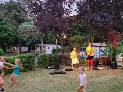 a group of children playing in a yard with a band at Mobil-Home Confort 4 Pers. à Pamiers - API-1-52-1960 in Pamiers