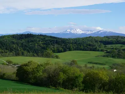 a green field with snow capped mountains in the distance at Mobil-Home Confort 4 Pers. à Pamiers - API-1-52-1960 in Pamiers