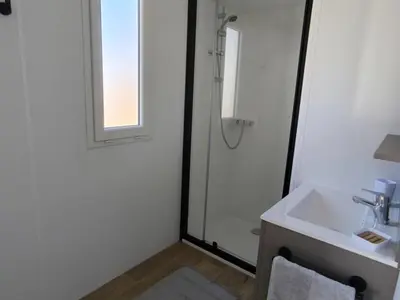 a white bathroom with a sink and a shower at Mobil-home cosy pour 2 à Pamiers - API-1-52-1959 in Pamiers