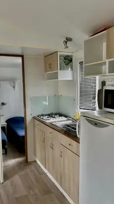 a kitchen with a sink and a stove top oven at Mobil-home camping Port-la-nouvelle in Port-la-Nouvelle
