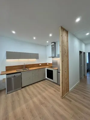 an empty kitchen with a sink and a counter at T2 centre-ville rénové avec goût in Narbonne