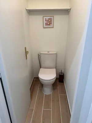 a bathroom with a toilet in a small room at T2 centre-ville rénové avec goût in Narbonne