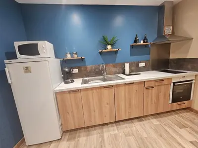 a living room with a bed and a kitchen at modern studio ground floor Wi-Fi TV parking in Salses-le-Chateau