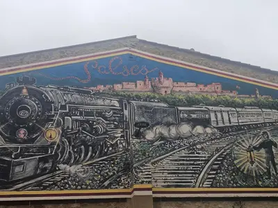 a mural of a train on the side of a building at modern studio ground floor Wi-Fi TV parking in Salses-le-Chateau