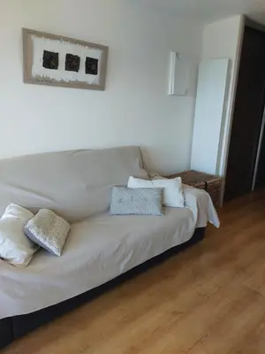 a white bed with pillows on it in a room at Le Grand Large in Gruissan