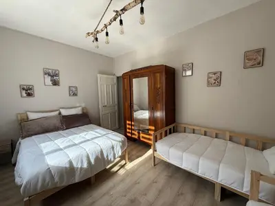 a bedroom with two beds and a mirror at Maison de village in Montferrier