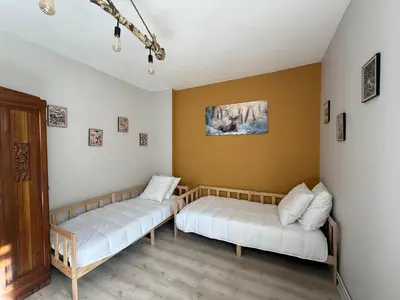 a room with two beds and a couch at Maison de village in Montferrier