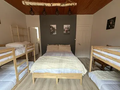 a room with two beds and two trunks at Maison de village in Montferrier