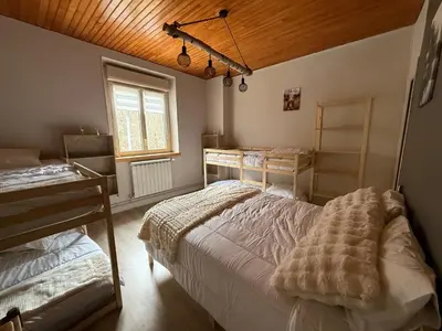a bedroom with two beds and a window at Maison de village in Montferrier