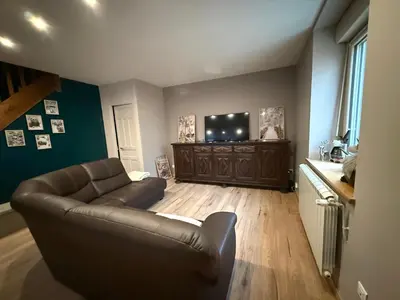 a living room with a couch and a flat screen tv at Maison de village in Montferrier
