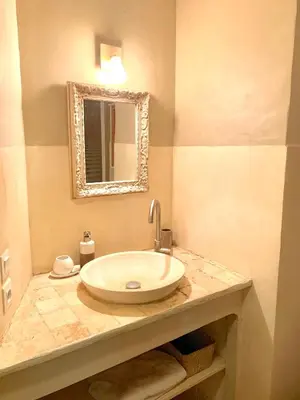 a bathroom with a sink and a mirror at Le Castillou in Luc-sur-Aude