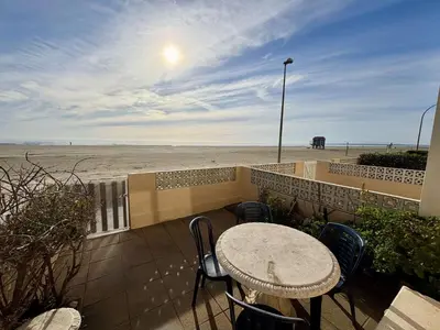 a table and chairs on a patio near the beach at Appt 2 pièces 4 couchages PORT LA NOUVELLE PN730-007 in Port-la-Nouvelle
