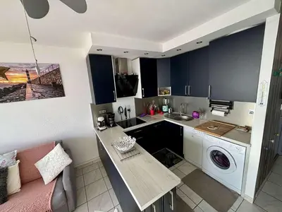 a kitchen with a sink and a washing machine at Appt 2 pièces 4 couchages PORT LA NOUVELLE PN730-007 in Port-la-Nouvelle