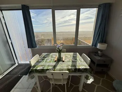 a dining room with a table with a view of the desert at Appt 2 pièces 4 couchages PORT LA NOUVELLE PN730-007 in Port-la-Nouvelle