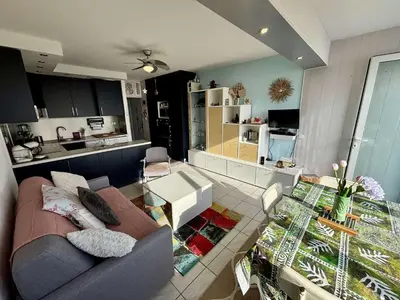 a living room with a couch and a kitchen at Appt 2 pièces 4 couchages PORT LA NOUVELLE PN730-007 in Port-la-Nouvelle