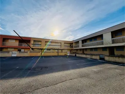 an empty parking lot in front of a building at Appt 2 pièces 4 couchages PORT LA NOUVELLE PN730-007 in Port-la-Nouvelle