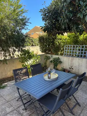 a blue table and chairs on a patio at Fleur de sel in Gruissan