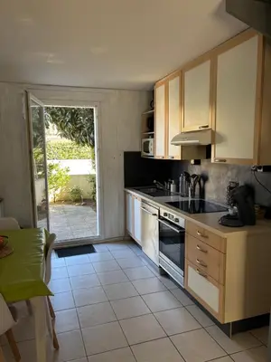 a kitchen with a sink and a stove at Fleur de sel in Gruissan