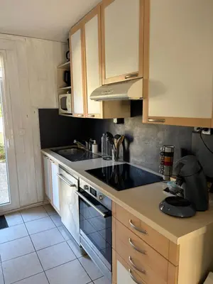 a kitchen with a sink and a stove at Fleur de sel in Gruissan
