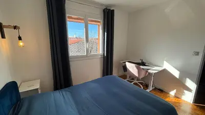 a bedroom with a blue bed and a window at Maison standing 5 chambres Jardin et Garage in Aussillon