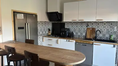a room with a desk and a table and a chair at Maison standing 5 chambres Jardin et Garage in Aussillon
