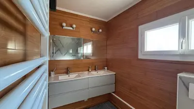 a bathroom with two sinks and a mirror at Maison standing 5 chambres Jardin et Garage in Aussillon