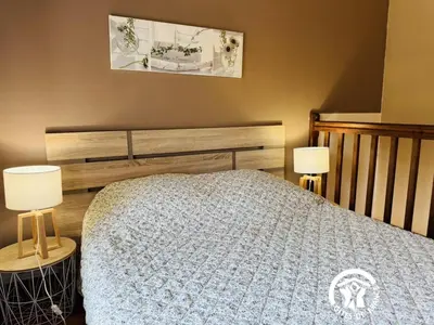 a bedroom with a bed and two lamps on tables at La ventaillole in Ventenac-Cabardès