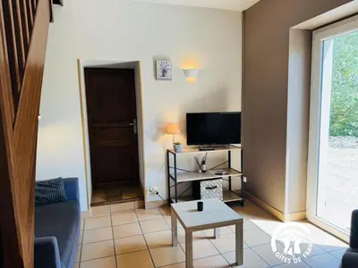 a living room with a couch and a television at La ventaillole in Ventenac-Cabardès