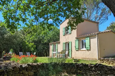 an old house with a stone wall in front of it at La ventaillole in Ventenac-Cabardès
