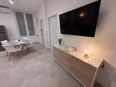 a living room with a large tv on the wall at Le Diamant in Narbonne
