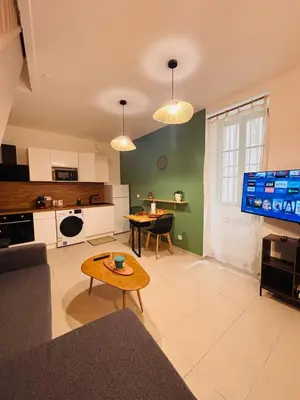 a living room with a couch and a table at Appartement duplex cœur de ville in Narbonne