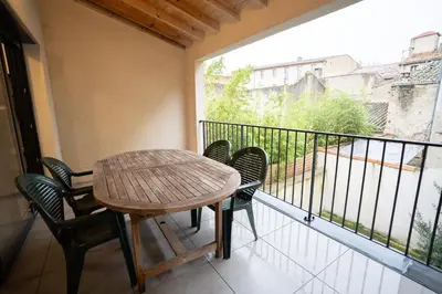 a table and chairs on a balcony with a view at Air-conditioned 2 bedroom apartment with Terrace Parking Carcassonne in Carcassonne