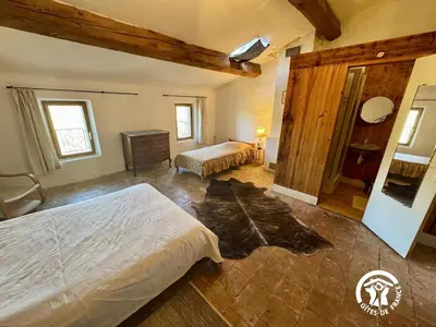 a bedroom with two beds and a dresser in it at La maison in Davejean