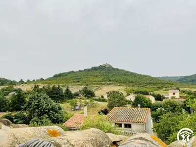 a small village with a mountain in the background at La maison in Davejean