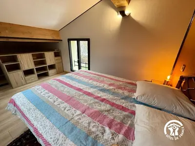 a bedroom with a bed with a quilt on it at Grand sissou in Bugarach