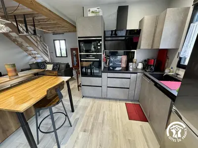 a kitchen with a wooden table and a counter top at Grand sissou in Bugarach