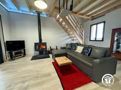 a living room with a couch and a fireplace at Grand sissou in Bugarach