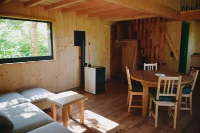 a living room with a couch and a table in a room at Les Gîtes de Montbel, nestled in nature in Montbel