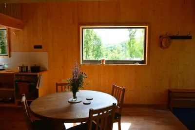 a dining room with a table and a window at Les Gîtes de Montbel, nestled in nature in Montbel
