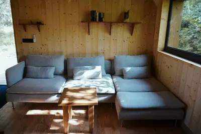 a living room with a couch and a table at Les Gîtes de Montbel, nestled in nature in Montbel