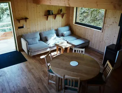 a living room with a couch and a table at Les Gîtes de Montbel, nestled in nature in Montbel