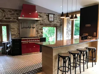 a living room with a black chair and a staircase at Camping 3 étoiles - ccbfdca in Le Bez