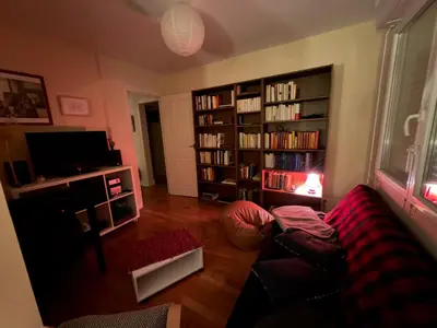 a living room with a couch and a book shelf at Regard du planteur d'arbres in Saint-Paul-de-Fenouillet