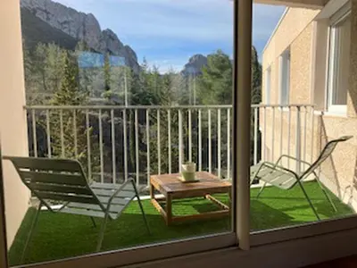 a view of a balcony with a table and chairs at Regard du planteur d'arbres in Saint-Paul-de-Fenouillet