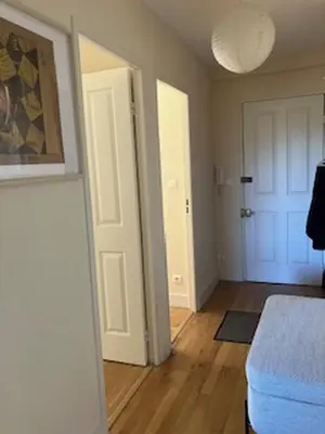 a living room with a white door and a room with a bed at Regard du planteur d'arbres in Saint-Paul-de-Fenouillet