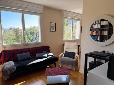 a living room with a couch and a chair at Regard du planteur d'arbres in Saint-Paul-de-Fenouillet