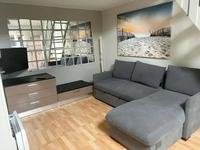 a living room with a couch and a staircase at Pavillon Bord de mer Gruisan in Gruissan