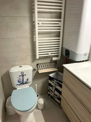 a kitchen with a black and white counter top at Pavillon Bord de mer Gruisan in Gruissan